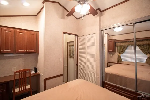 a bedroom with a bed a chandelier and closet