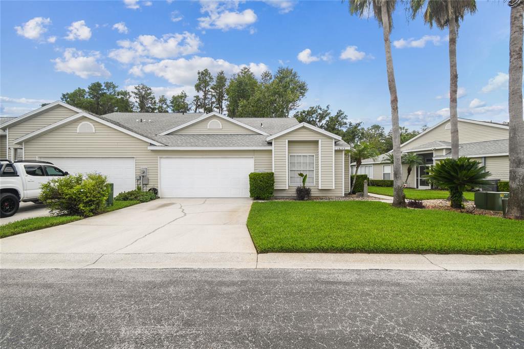 1639 Send Way Lutz, FL 33549 - Photo 1 of 1 a front view of a house with a garden and plants