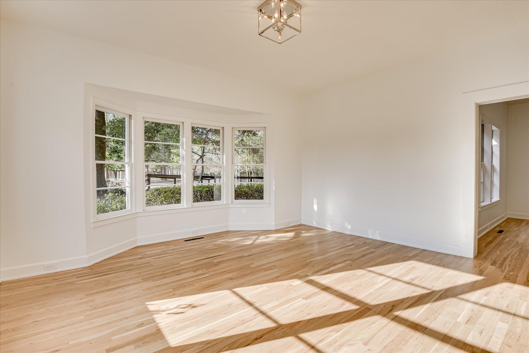 126 Mosley Road Aiken, SC 29801 - Photo 4 of 29 a view of an empty room with wooden floor and a window