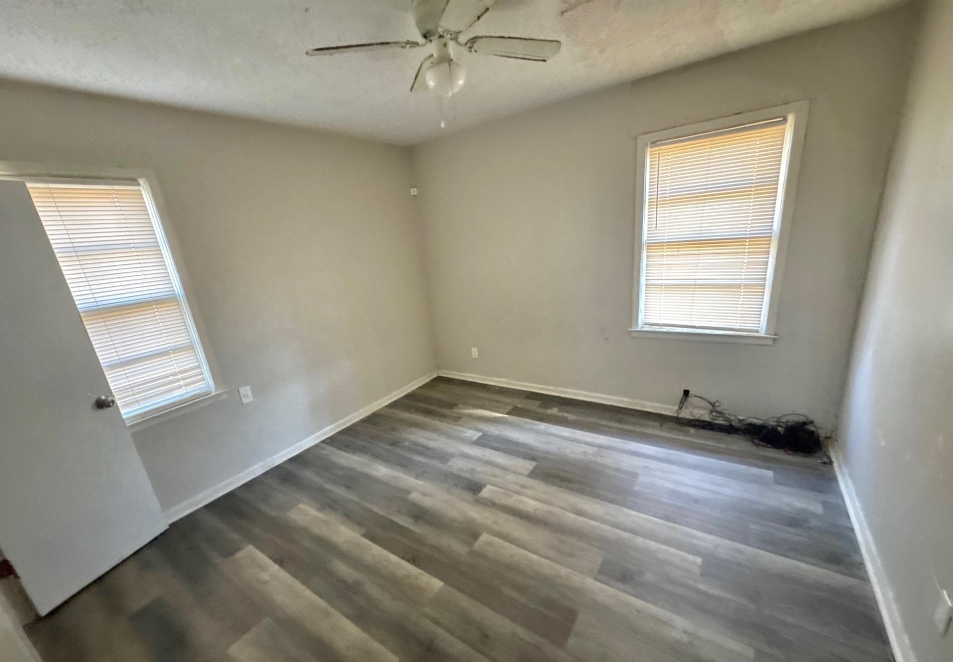 4826 Leonard Road Memphis, TN 38109 - Photo 5 of 8 Spare room featuring dark wood-style floors and ceiling fan