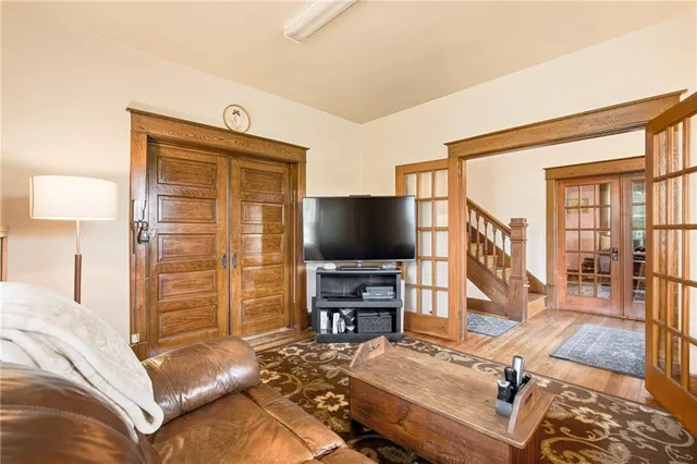 a view of a hallway with wooden floor and staircase