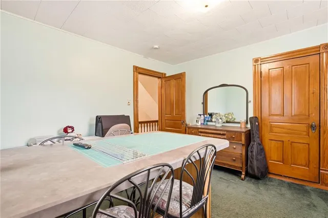 a bedroom with a bed chairs and a chandelier