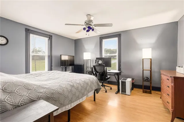 a view of a bedroom with furniture and large windows