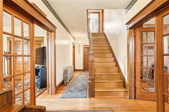 a living room with furniture a rug and a floor to ceiling window