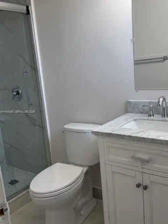 a white toilet sitting next to a bathroom sink