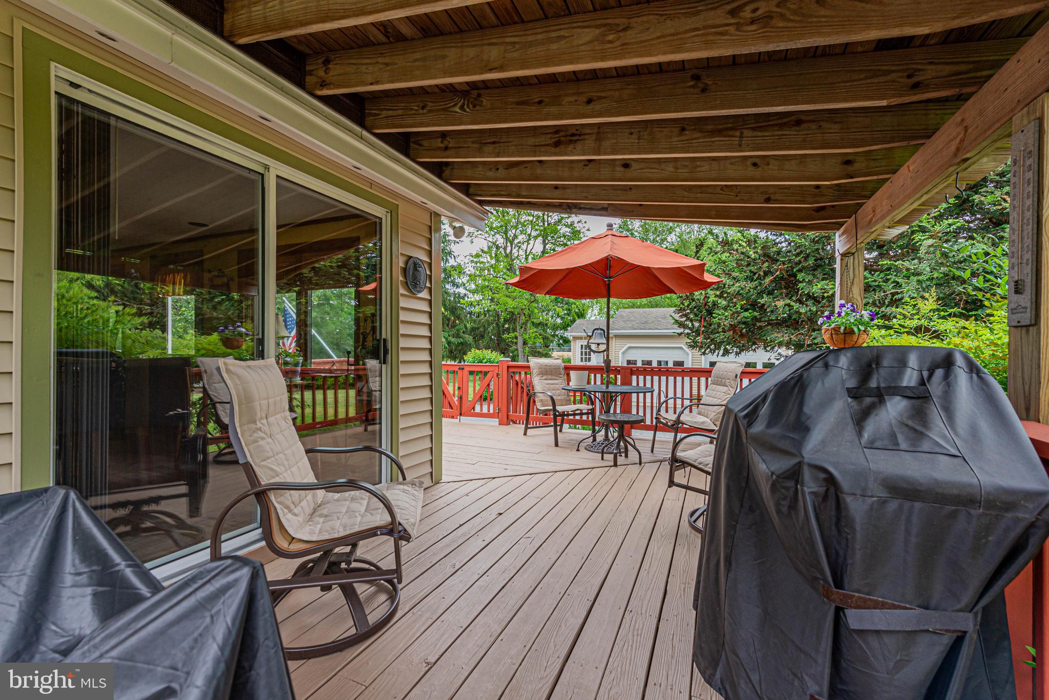 31468 Wingate Road Dagsboro, DE 19939 - Photo 42 of 48 a view of patio with table and chairs under an umbrella with a small yard