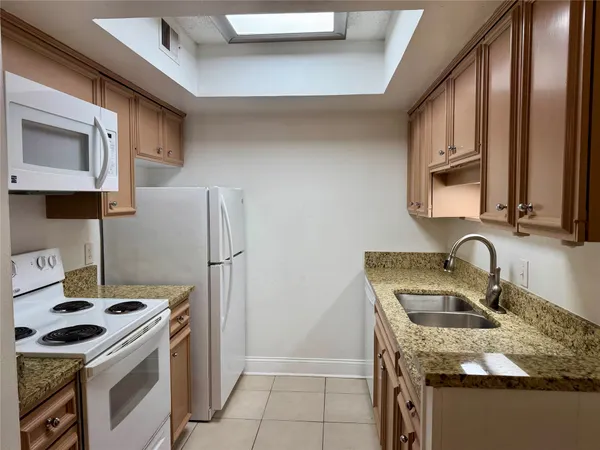 a walk in closet with wooden floor