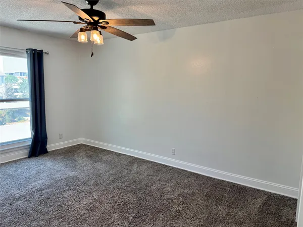 a view of a room with closet and a ceiling fan