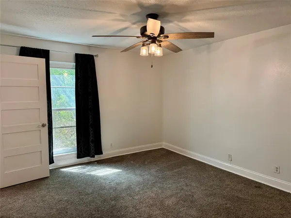 a bathroom with a granite countertop sink a mirror and a toilet