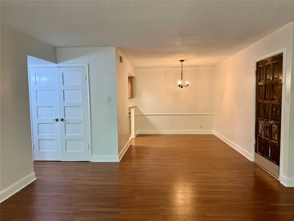 a view of a kitchen with a stove wooden floor and a window