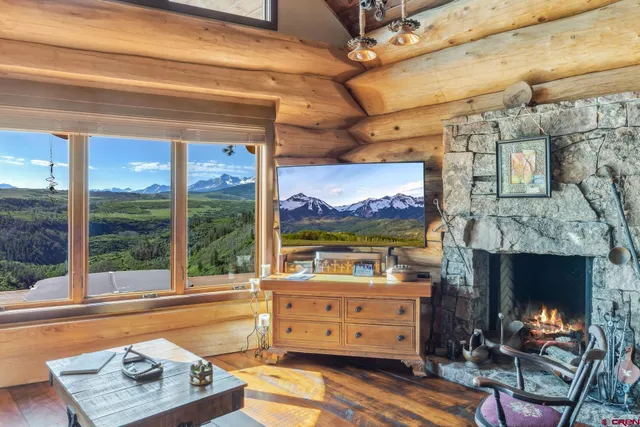 a view of a dining room with furniture large windows and wooden floor