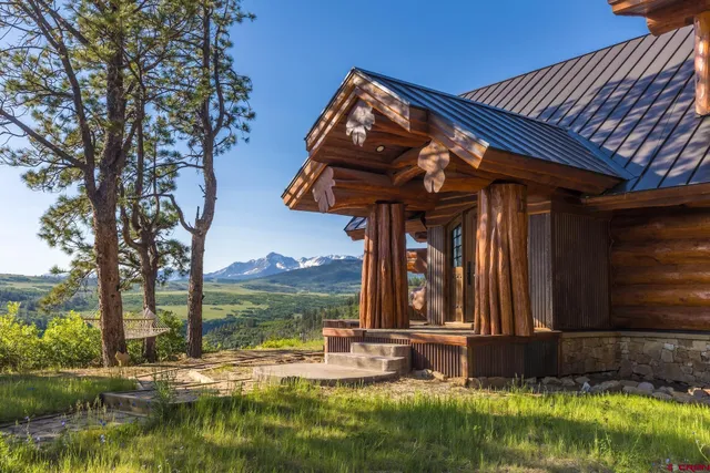 a view of a house with a yard and floor to ceiling window