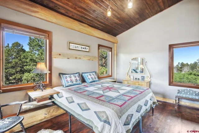 a bedroom with a bed and a painting on the wall