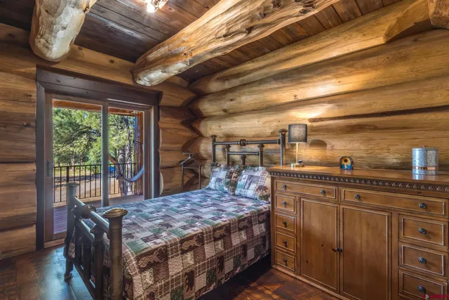 a bedroom with a bed and a mirror