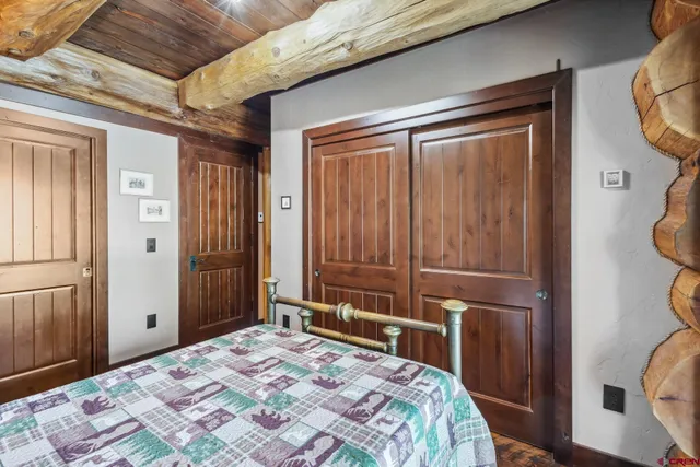 a bathroom with a granite countertop sink a toilet and a mirror