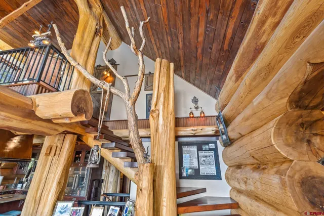 a front view of a house with a tree