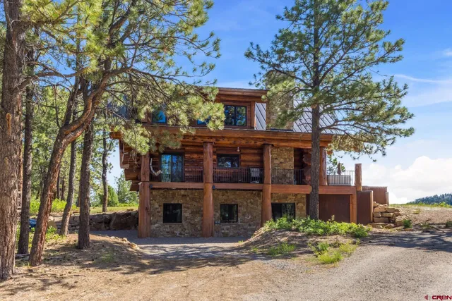 a view of a house with a small yard and a fountain
