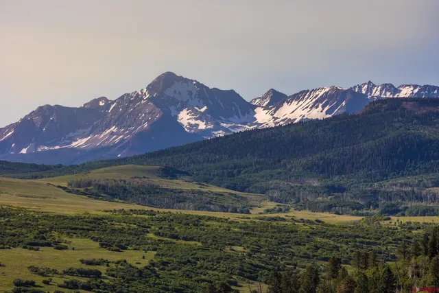 a view of a large building with a mountain in the background
