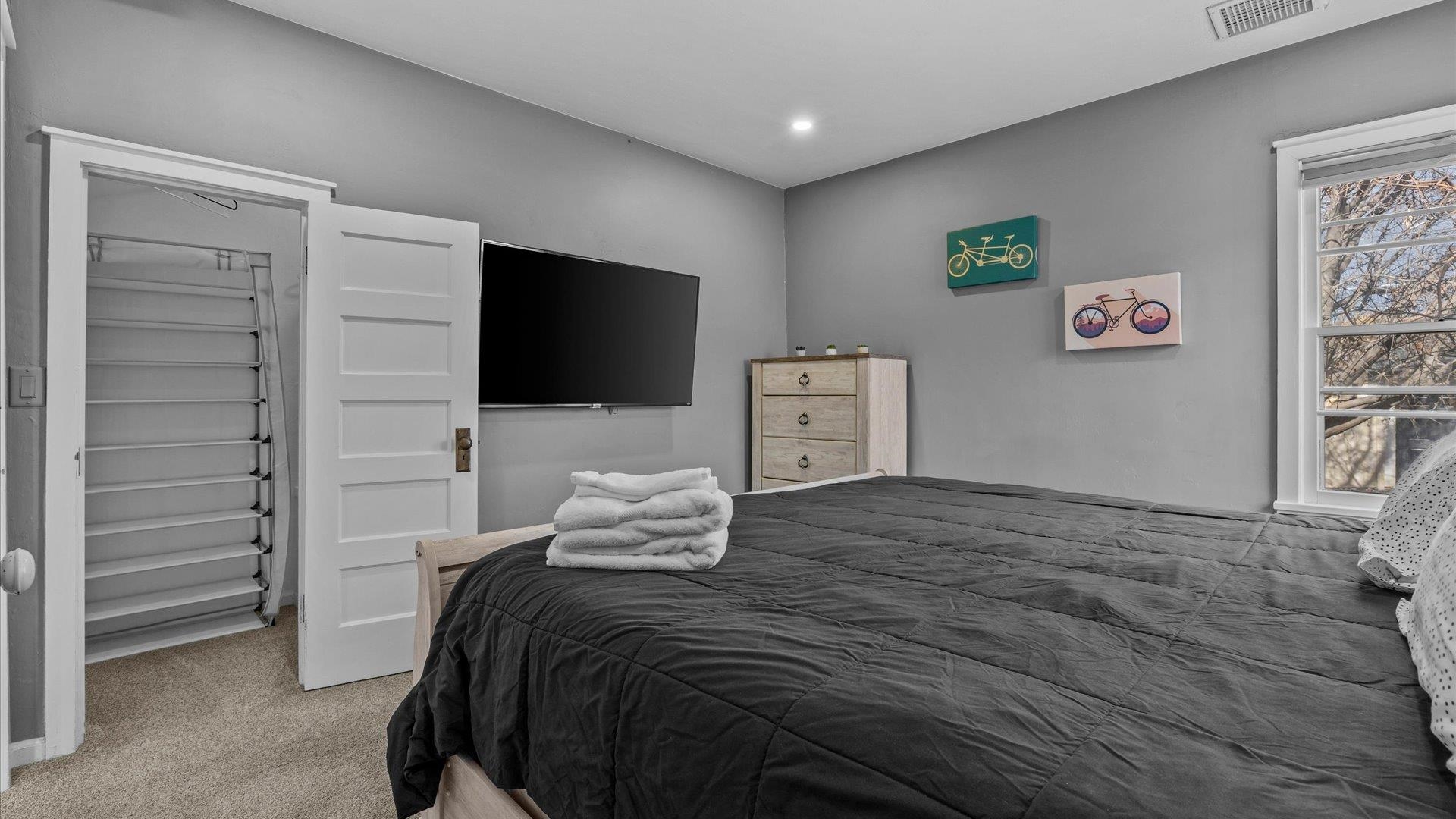 829 East Aspen Avenue Fruita, CO 81521 - Photo 14 of 27 a bedroom with a bed and a flat screen tv