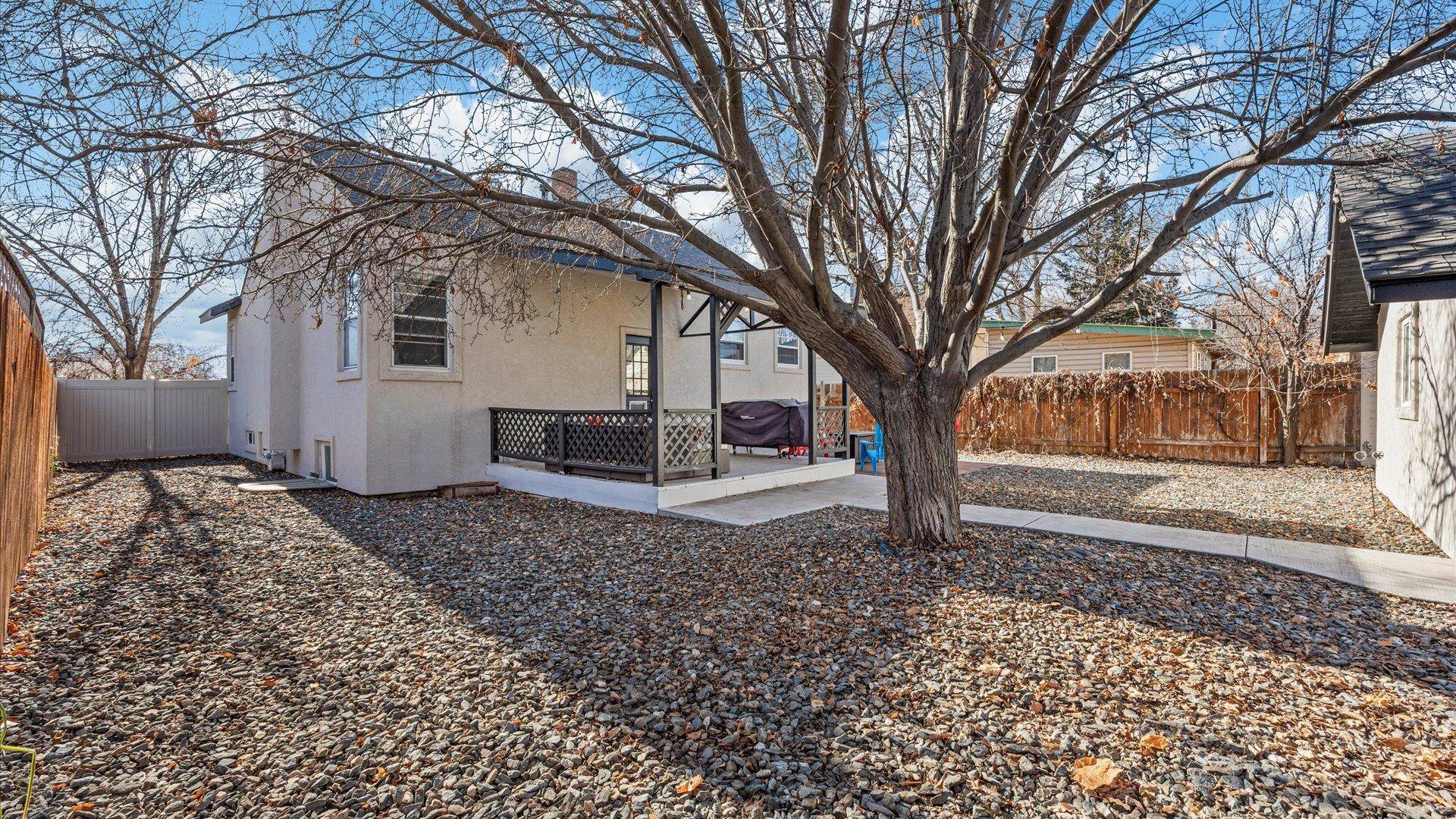 829 East Aspen Avenue Fruita, CO 81521 - Photo 23 of 27 a white house that has a tree in front of it