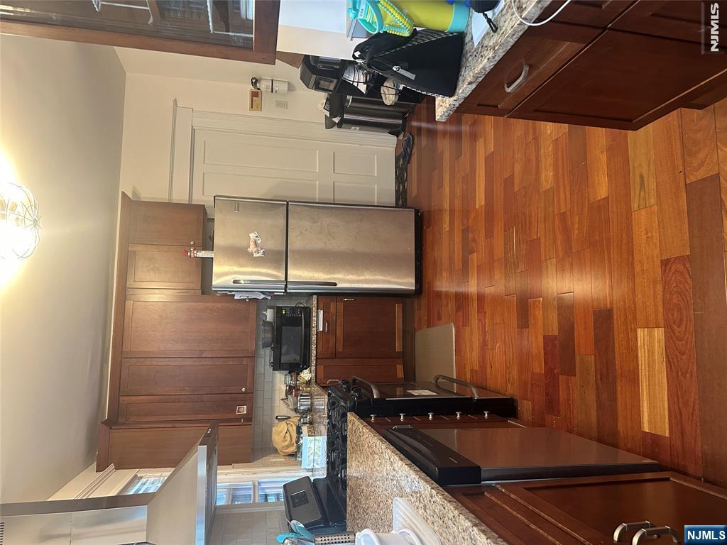 23 Highland Cross, Unit 1 Rutherford, NJ 07070 - Photo 8 of 11 a kitchen with a refrigerator a stove top oven a sink and dishwasher