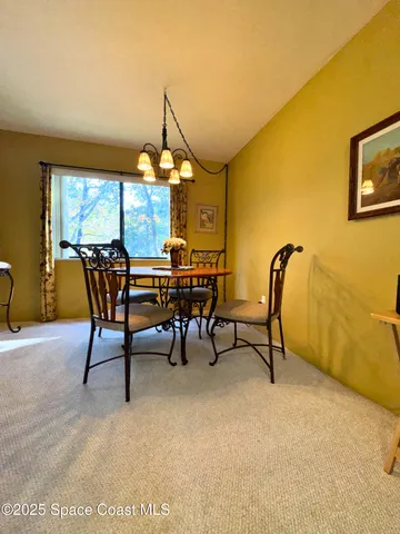 a view of a livingroom with furniture and a table chair