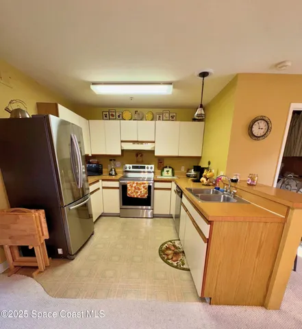 a kitchen with a sink appliances and cabinets
