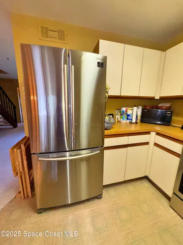 a white refrigerator freezer sitting in a kitchen