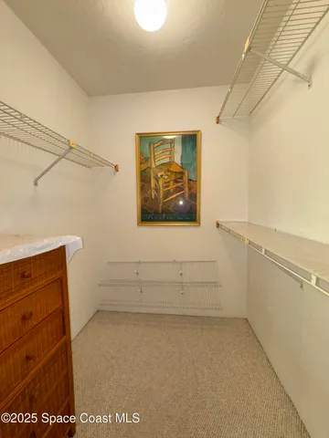 a view of storage and utility room with a window