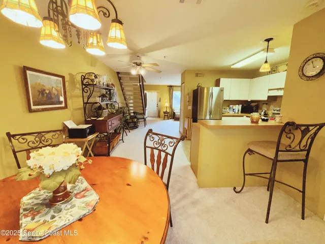 a living room with lots of furniture and a chandelier