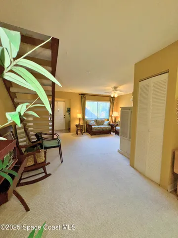a view of a livingroom with furniture and a window