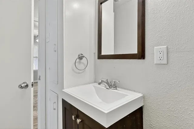 a bathroom with a sink vanity and a mirror