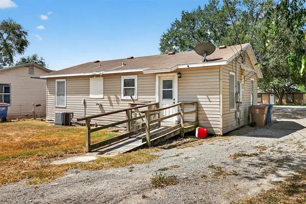 a view of a house with a yard covered in snow