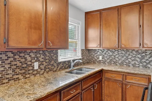 a kitchen with sink cabinets and window