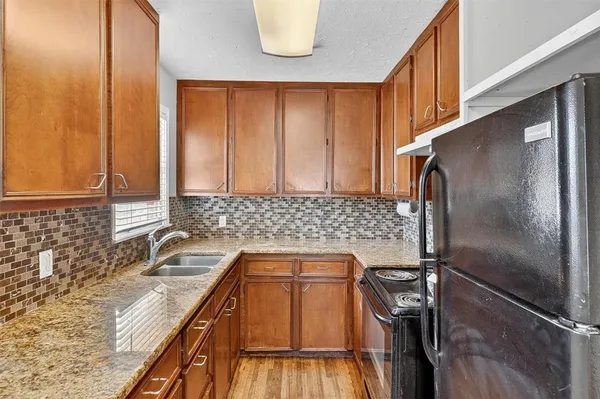 a kitchen with a refrigerator and a sink