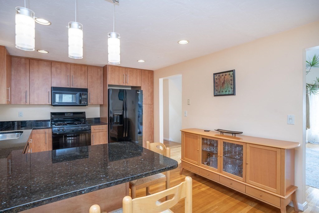 25 Sandy Ridge Road Stoughton, MA 02072 - Photo 17 of 42 a kitchen with stainless steel appliances granite countertop a sink stove and refrigerator