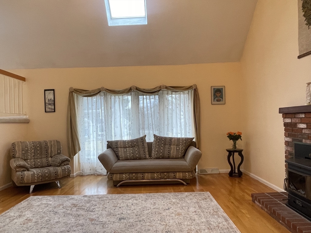 25 Sandy Ridge Road Stoughton, MA 02072 - Photo 2 of 42 a living room with furniture a rug and a couch