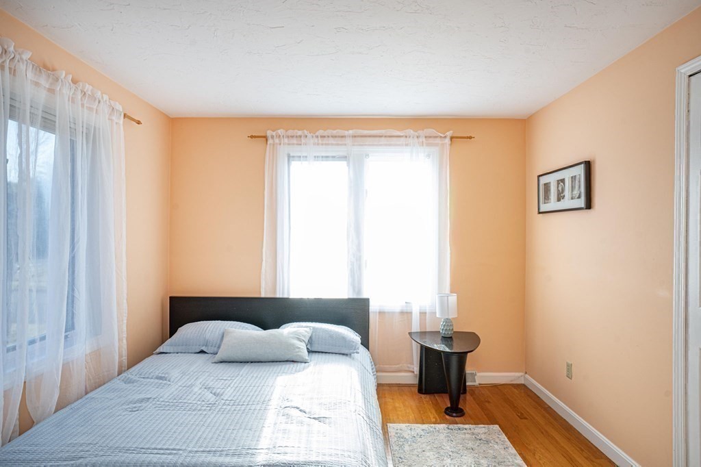 25 Sandy Ridge Road Stoughton, MA 02072 - Photo 24 of 42 a bedroom with a bed and wooden floor