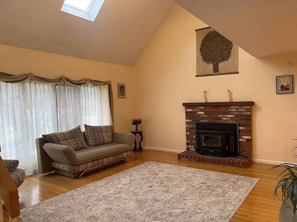 25 Sandy Ridge Road Stoughton, MA 02072 - Photo 3 of 42 a living room with furniture and a fireplace