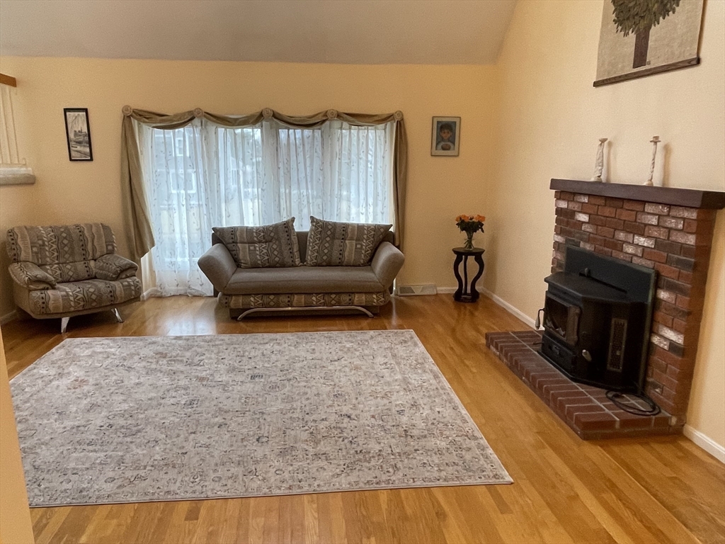 25 Sandy Ridge Road Stoughton, MA 02072 - Photo 5 of 42 a living room with furniture and a fireplace