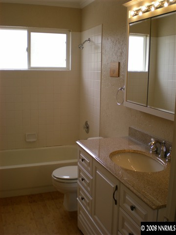 1440 Moon Lane Reno, NV 89521 - Photo 9 of 9 a bathroom with a granite countertop toilet a sink and mirror