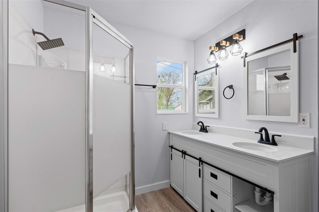 1205 Southwest 12th Street Mineral Wells, TX 76067 - Photo 18 of 23 a bathroom with a double vanity sink mirror and
