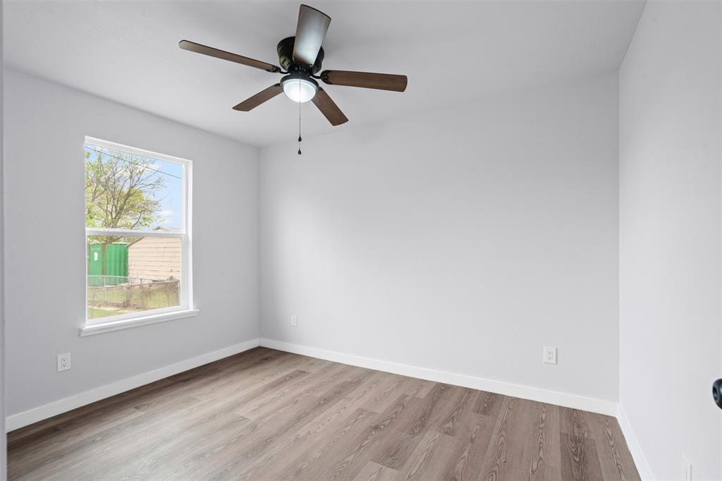 1205 Southwest 12th Street Mineral Wells, TX 76067 - Photo 20 of 23 an empty room with a window and a fan
