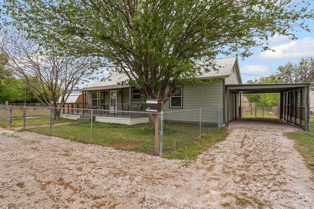 1205 Southwest 12th Street Mineral Wells, TX 76067 - Photo 4 of 23 front view of a house with a yard