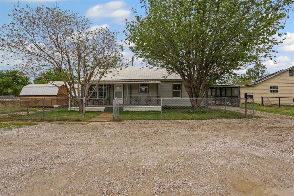 1205 Southwest 12th Street Mineral Wells, TX 76067 - Photo 5 of 23 a front view of a house with a yard
