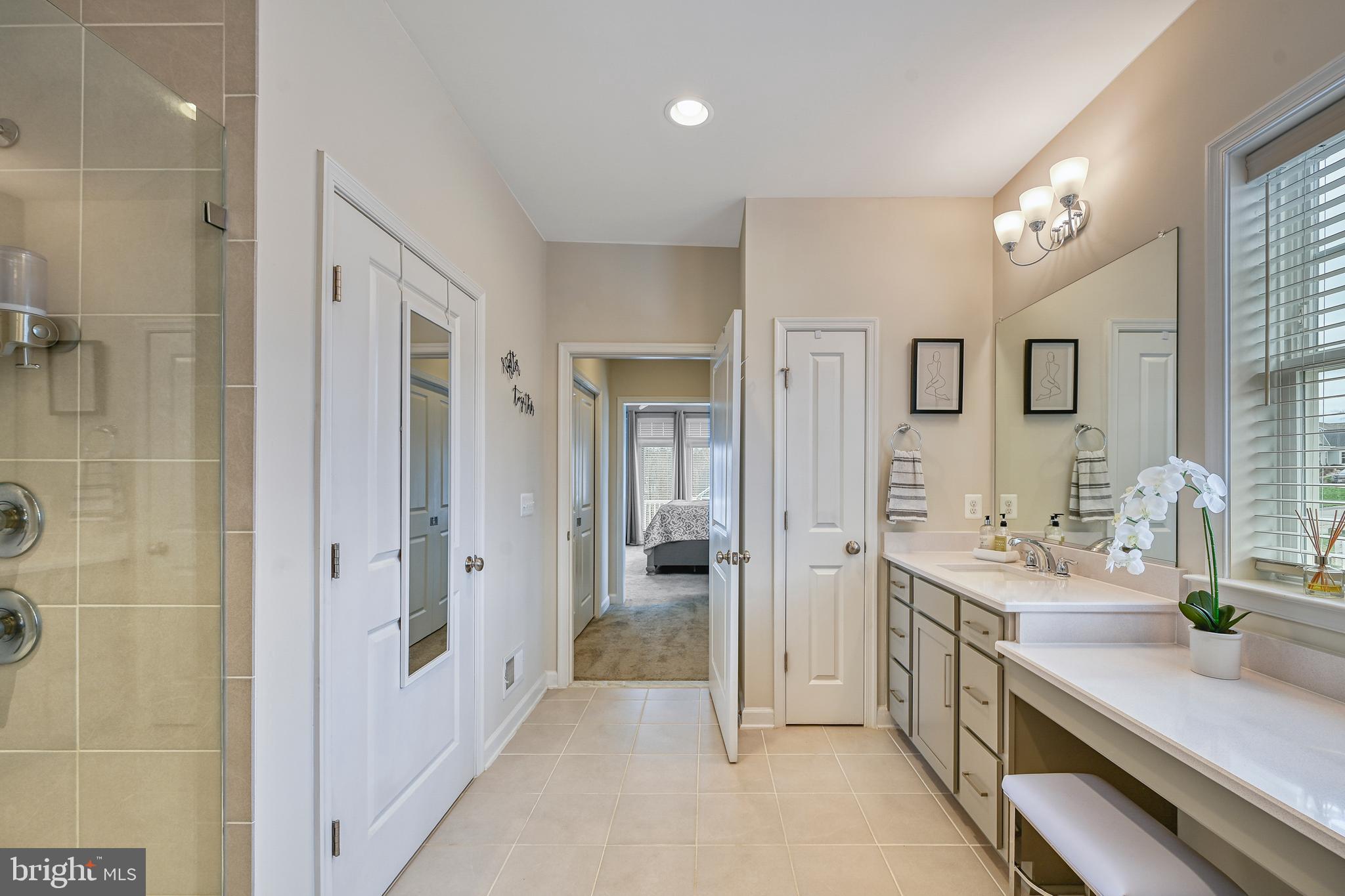 287 Sunset Loop Mineral, VA 23117 - Photo 53 of 112 a bathroom with a double vanity sink a mirror and a shower