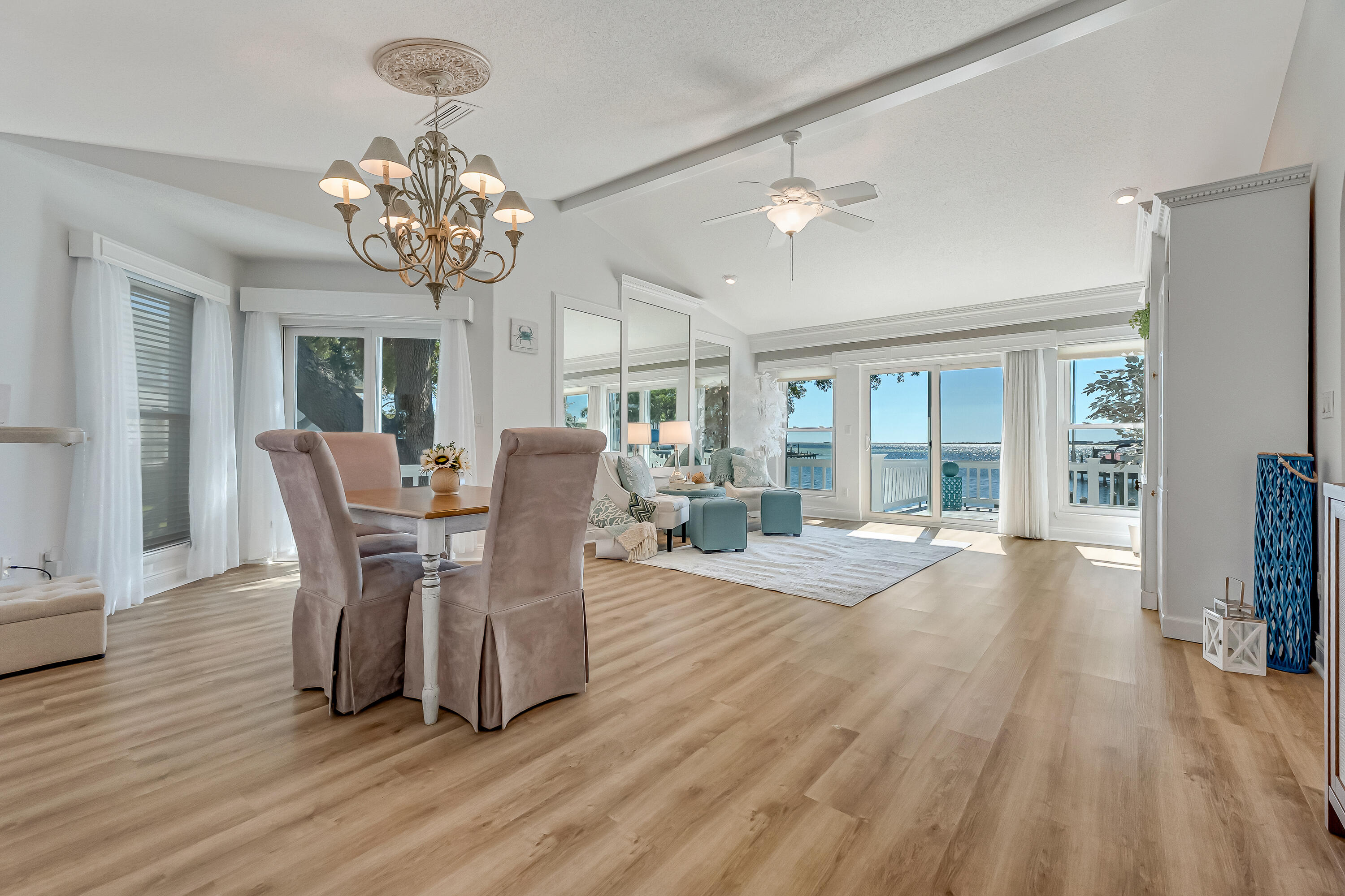 101 Port Drive Shalimar, FL 32579 - Photo 21 of 45 a view of a dining room with furniture a chandelier and wooden floor