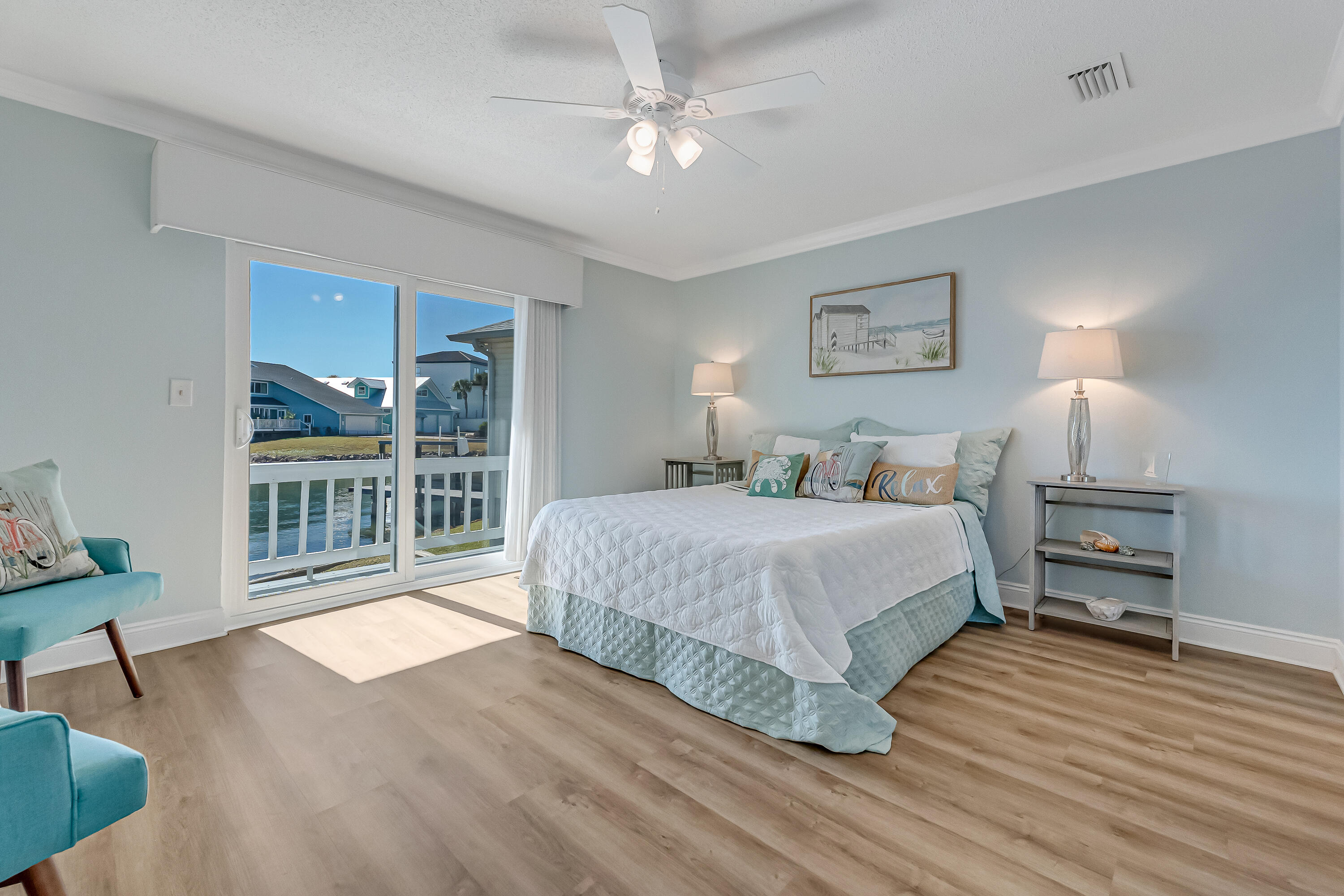 101 Port Drive Shalimar, FL 32579 - Photo 30 of 45 a spacious bedroom with a large bed and a chandelier