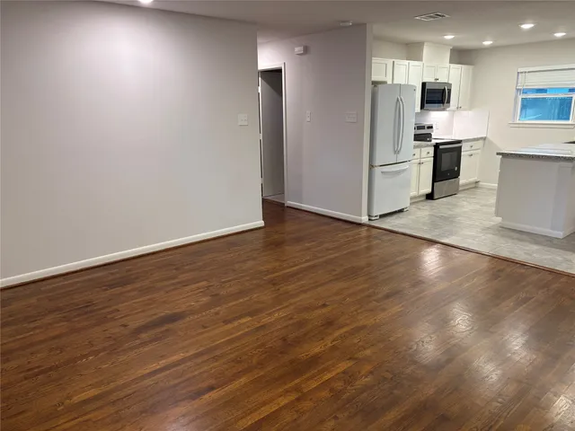 a view of kitchen view wooden floor and electronic appliances