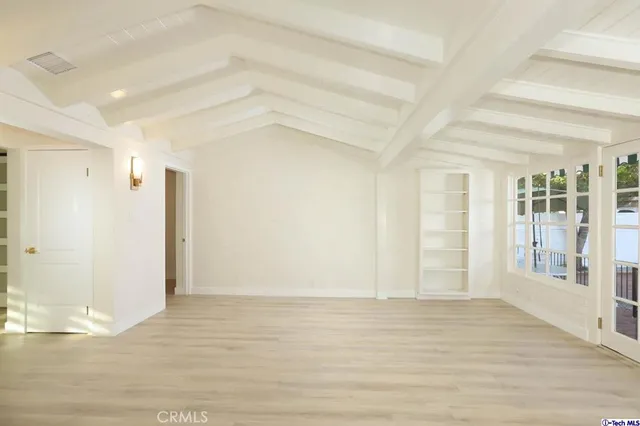 a kitchen with refrigerator and cabinets